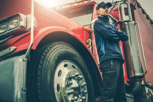 american truck driver in front of his truck